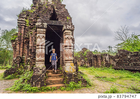 Boy tourist in Temple ruin of the My Son complex, Vietnam. Vietnam opens to tourists again after quarantine Coronovirus COVID 19 83794747