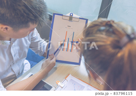 Close up of businessman and businesswoman discuss about sales report Close up of businessman and businesswoman discuss about sales report 83796115
