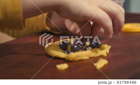 Exercise for the development of fine motor skills fingers. Children's hands press small balls into the plasticine. The development of the subcortchiation of the brain. High quality 4k footage Exercise for the development of fine motor skills fingers. Children's hands press small balls into the plasticine. The development of the subcortchiation of the brain. High quality 4k footage 83796486