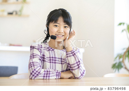 ヘッドセットをつけたカメラ目線の小学校高学年の女の子 83796498