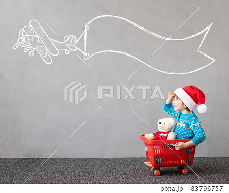 Happy child riding shopping cart. Christmas holiday concept Happy child riding shopping cart. Christmas holiday concept 83796757