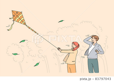 Happy father and daughter play with paper kite in park  83797043