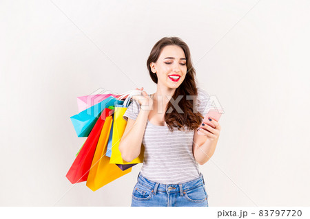 Young beautiful model with lots of shopping bags in hands. Young beautiful model with lots of shopping bags in hands. 83797720