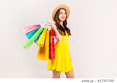 Young beautiful model with lots of shopping bags in hands. Young beautiful model with lots of shopping bags in hands. 83797760