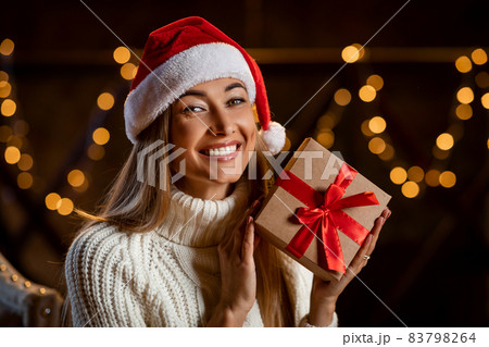Happy Woman Holding Christmas Present At Home 83798264