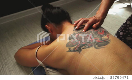 Top view. Handmade sensual massage on female nack on floor. 83799471