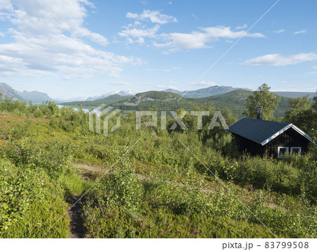 Mountain lodge on the shore of lake Lulealven, Lule river dam in Saltoluokta in birch forest in Sweden Lapland. Summer cabin on famous Kungsleden, Kings hiking trail Mountain lodge on the shore of lake Lulealven, Lule river dam in Saltoluokta in birch forest in Sweden Lapland. Summer cabin on famous Kungsleden, Kings hiking trail 83799508