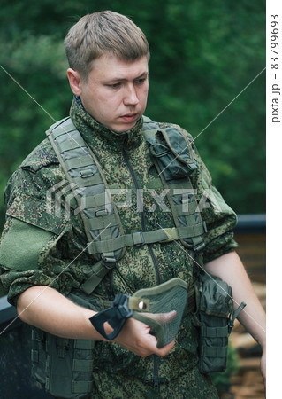 Military men with automatic weapons getting ready to play airsoft strikeball 83799693