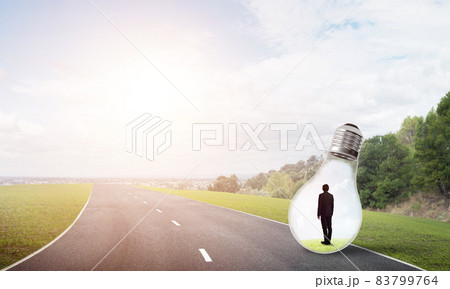Businessman inside light bulb Businessman inside light bulb 83799764