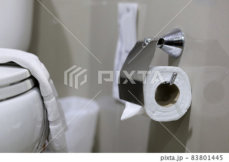 Clean toilet paper in the bathroom. Being folded and being used for the hotel guests 83801445