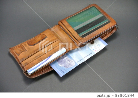RM1 notes and a old wallet isolated on white background 83801844