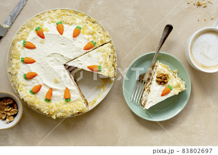 Carrot cake with walnuts an whipped cream, homemade easter cake baking, top view. Whole round cake. Carrot cake with walnuts an whipped cream, homemade easter cake baking, top view. Whole round cake. 83802697