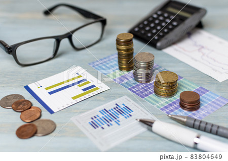 reading glasses piles coins high view. High quality beautiful photo concept 83804649