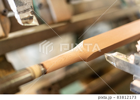 Wooden baluster lathe, unfocused background, shaped. Carpentry Wooden baluster lathe, unfocused background, shaped. Carpentry 83812173