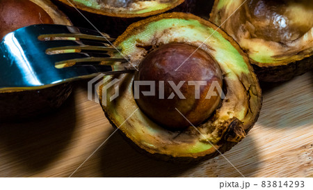 Close up Bad Avocado. Ugly Tropical fruits. Contaminated Avocado halfs. Necomestibile Fruits. Details Overripe Avocado. Unhelthy food Concept. 83814293