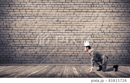 King businessman in elegant suit running in empty room with wooden floor 83815726