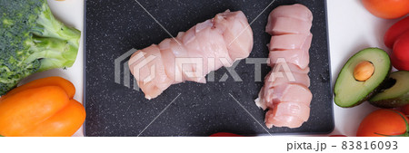 Freshly sliced meat and vegetables on table closeup 83816093