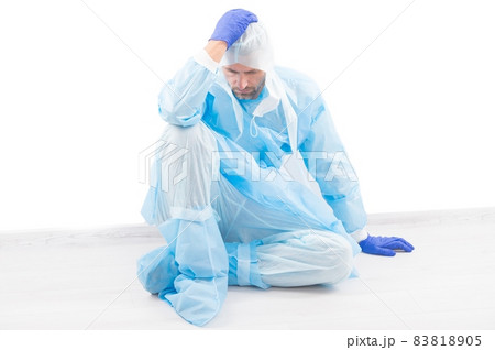 tired medical worker man sit in protective costume 83818905