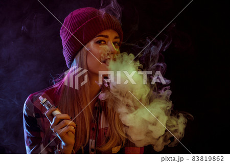 young woman smoking electronic cigarette young woman smoking electronic cigarette 83819862