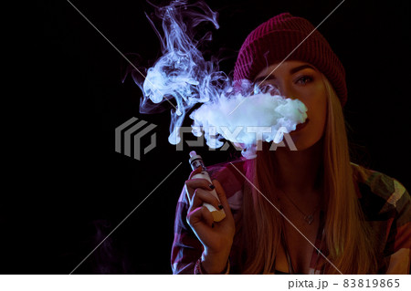 young woman smoking electronic cigarette young woman smoking electronic cigarette 83819865
