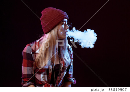 young woman smoking electronic cigarette young woman smoking electronic cigarette 83819907
