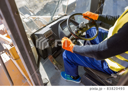 Male worker driving industrial vehicle at factory Male worker driving industrial vehicle at factory 83820493