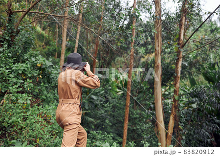 Beautiful young female caucasian tourist in equatorial africa jungles 83820912