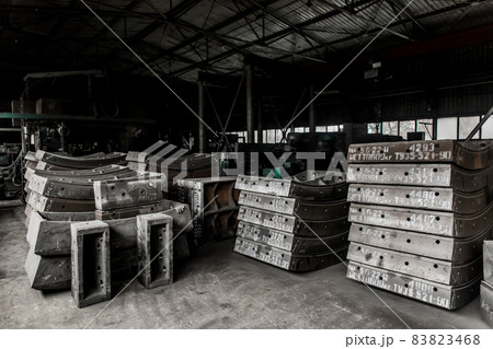 Cast iron tubing reinforced concrete cast products for lining distillation tunnels and underground structures are stored in the warehouse of the industrial plant Cast iron tubing reinforced concrete cast products for lining distillation tunnels and underground structures are stored in the warehouse of the industrial plant 83823468