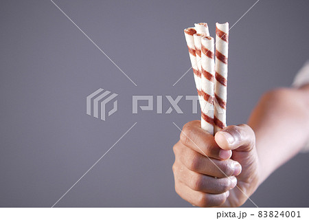 child hand hold chocolate wafer with copy space child hand hold chocolate wafer with copy space 83824001
