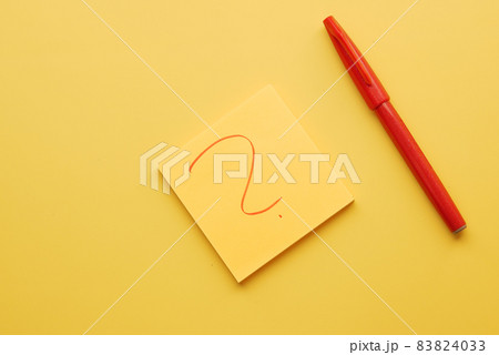 high angle view of question mark on paper on yellow background high angle view of question mark on paper on yellow background 83824033