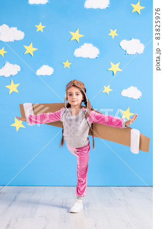 Girl pilot playing with toy jet pack at home. Success and leader concept 83825976