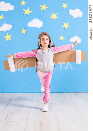 Girl pilot playing with toy jet pack at home. Success and leader concept 83825977