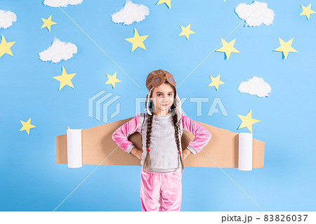 Little child girl in an astronaut costume is playing and dreaming of becoming a spaceman. Little child girl in an astronaut costume is playing and dreaming of becoming a spaceman. 83826037