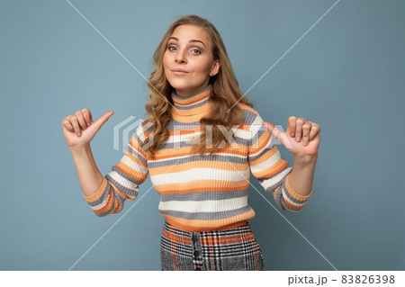 Portrait photo of young pretty beautiful attractive blonde woman with wavy-hair wearing striped Portrait photo of young pretty beautiful attractive blonde woman with wavy-hair wearing striped 83826398