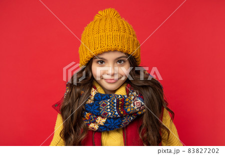 winter fashion. cheerful kid with curly hair in hat. female fashion model. teen girl in scarf. winter fashion. cheerful kid with curly hair in hat. female fashion model. teen girl in scarf. 83827202
