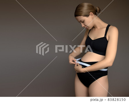 Beautiful pregnant young woman in clothes for 83828150