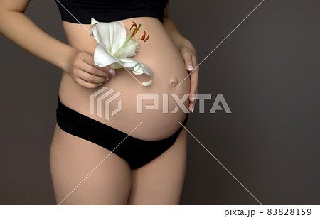 Beautiful pregnant young woman in clothes for 83828159