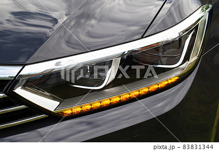 Economical and modern car headlight with LED adaptive light. Close-up, illuminate 83831344