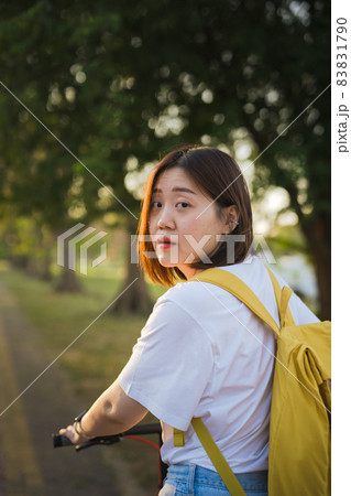 spring is comming concept with happy and cheerful feeling of asian woman riding bicycle 83831790