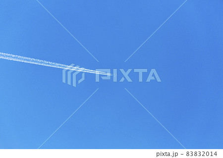Two engined airplane during flight in high altitude with condensation trails Two engined airplane during flight in high altitude with condensation trails 83832014