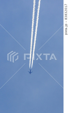 Two engined airplane during flight in high altitude with condensation trails Two engined airplane during flight in high altitude with condensation trails 83832017