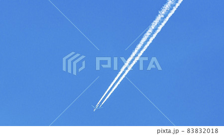 Two engined airplane during flight in high altitude with condensation trails Two engined airplane during flight in high altitude with condensation trails 83832018
