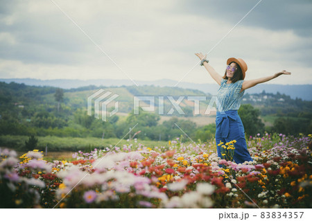 happy woman standing in beautiful blooming flower field 83834357