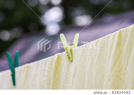 Freshly washed bed linen hanging on the rope outdoors. Freshly washed bed linen hanging on the rope outdoors. 83834592
