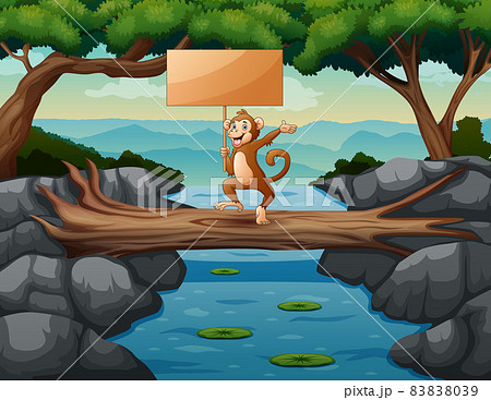 Funny a monkey holding wooden sign on the trunk 83838039