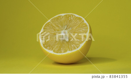 Sliced lemon on a yellow background. Sliced lemon on a yellow background. 83841355
