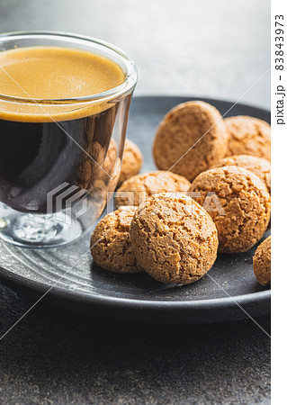 Amaretti biscuits. Sweet italian almond cookies and coffee cup 83843973