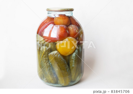 spoiled can of vegetable seaming. Glass jar with homemade pickled tomatos and cucumbers with white fungus spoiled can of vegetable seaming. Glass jar with homemade pickled tomatos and cucumbers with white fungus 83845706