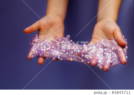 Making slime at home. child stretching colorful slime. DIY concept. Making slime at home. child stretching colorful slime. DIY concept. 83845711