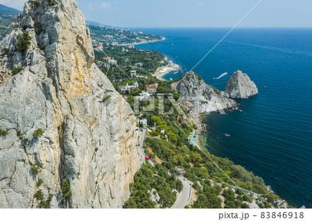 Aerial view of beautiful landscape of Simeiz area. Cat mountain, close up with Diva and Penea rocks inbackground. Beautiful coastline with beaches of Crimea Aerial view of beautiful landscape of Simeiz area. Cat mountain, close up with Diva and Penea rocks inbackground. Beautiful coastline with beaches of Crimea 83846918